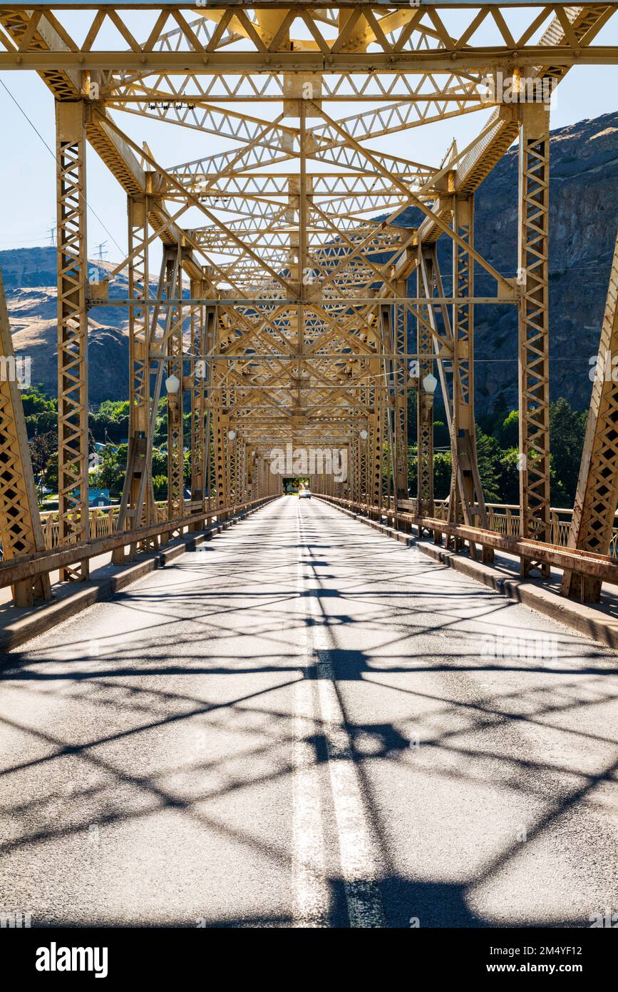 Steel structure of Grand Coulee Bridge casts abstract shadows on road
