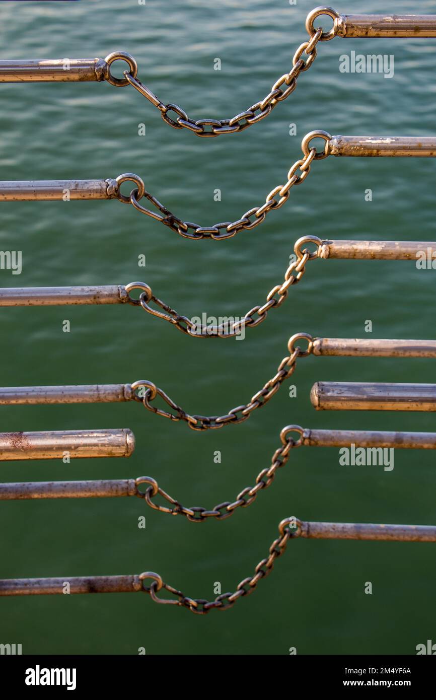 Chain connects two metal bars over a body of water Stock Photo Alamy