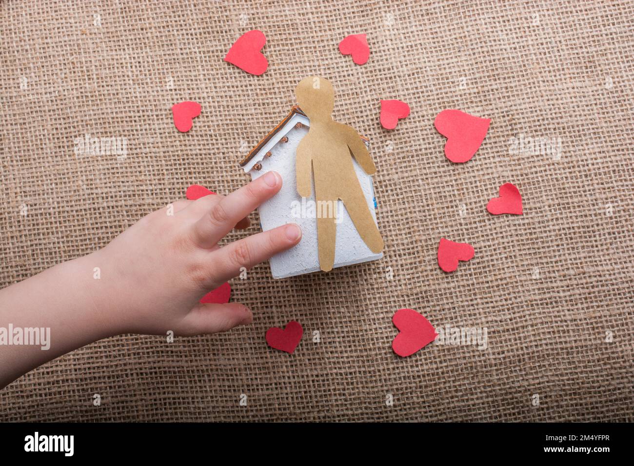 Heart shaped icons and paper house on canvas Stock Photo - Alamy