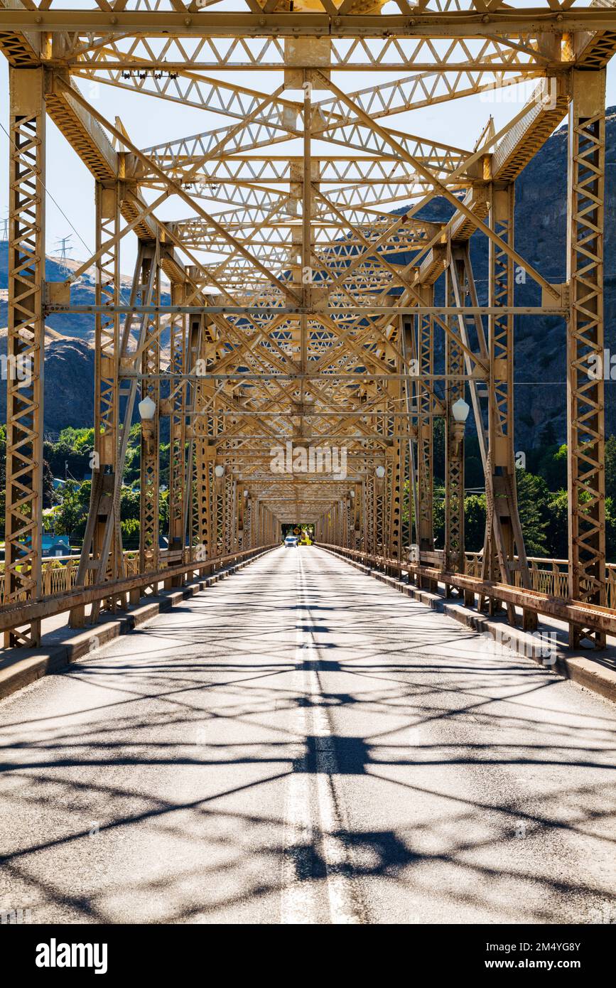 Steel structure of Grand Coulee Bridge casts abstract shadows on road
