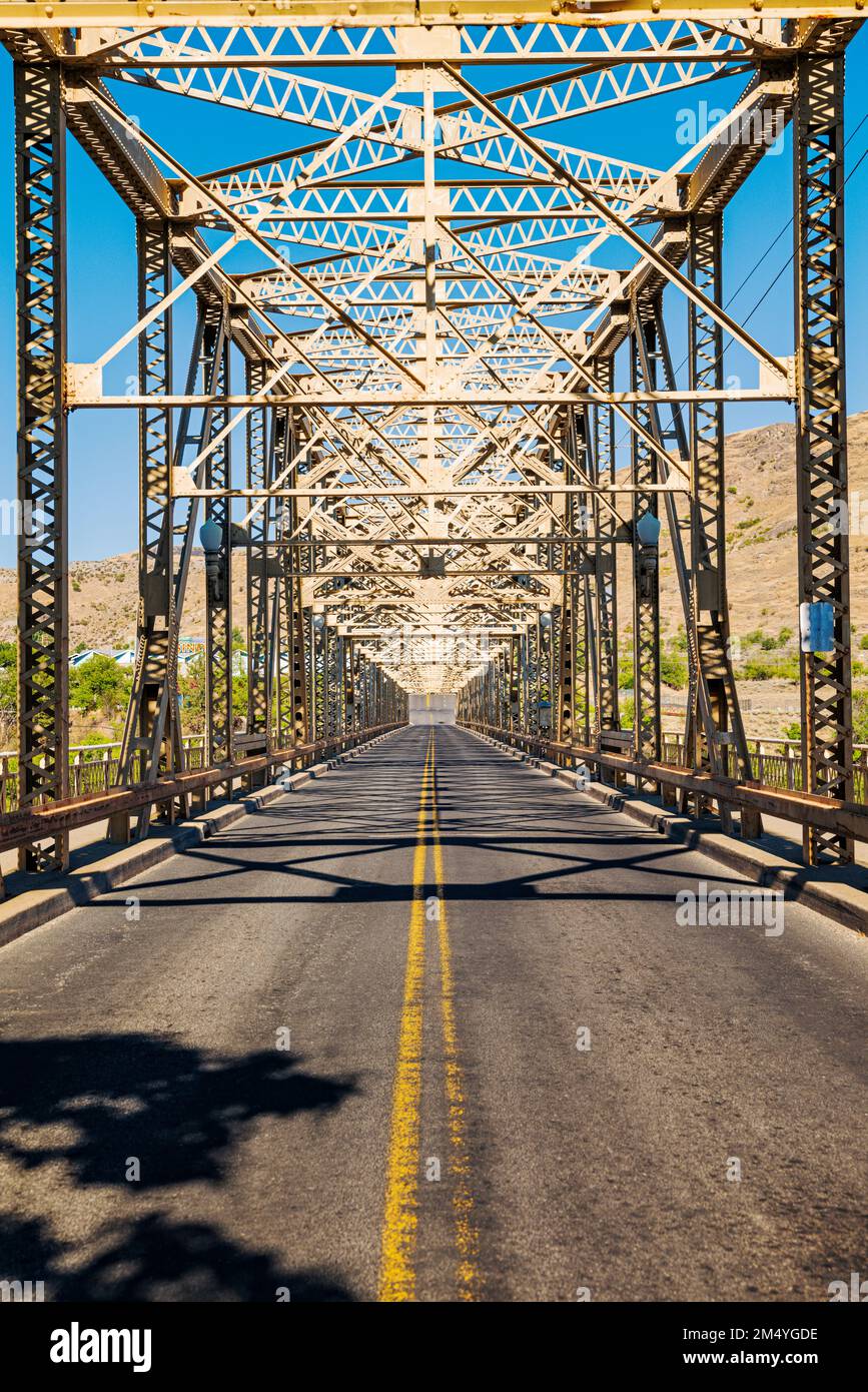 Steel structure of Grand Coulee Bridge casts abstract shadows on road; Grand Coulee; Washiington; USA Stock Photo