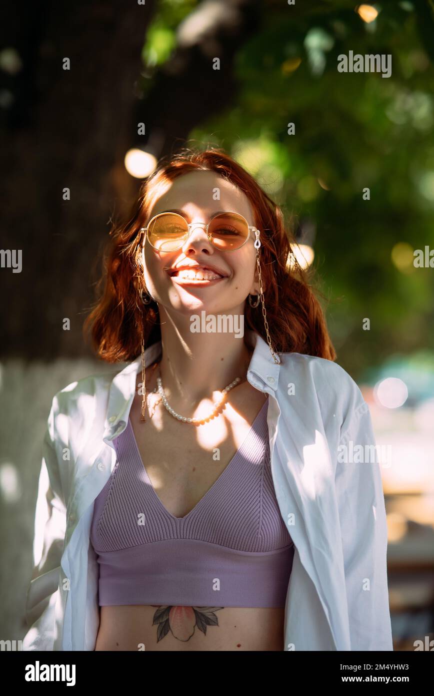 Young woman with toothy smile in outdoors Stock Photo - Alamy