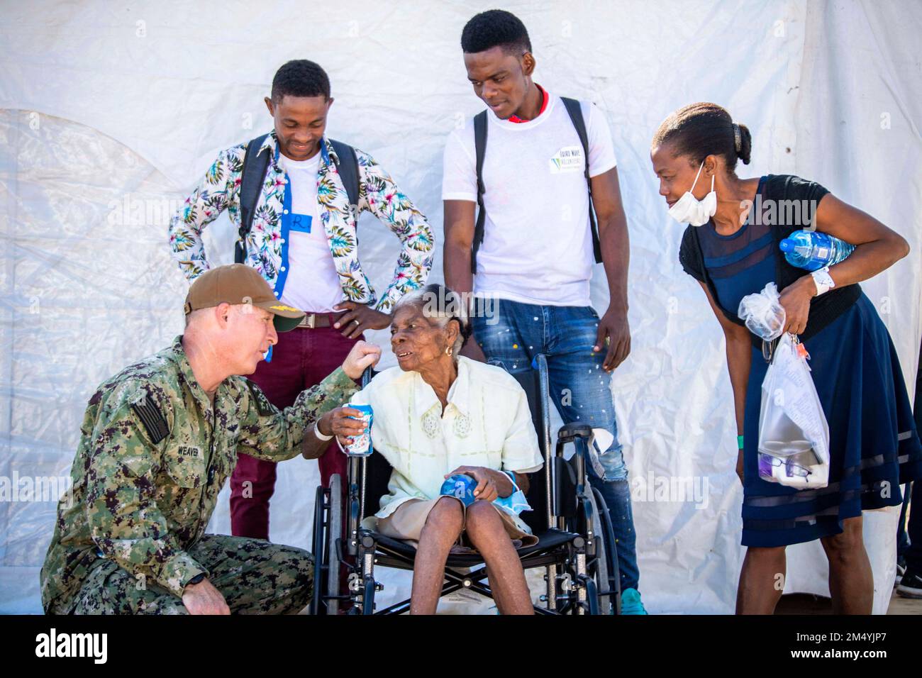 Jeremie, Haiti. 15th Dec, 2022. Capt. Michael Weaver, right, ground force commander for Continuing Promise 2022 in Haiti, talks to a patient after she received a wheelchair at the medical site in Jeremie, Haiti, December. 15, 2022. CP22 is a humanitarian assistance and goodwill mission conducting direct medical care, expeditionary veterinary care, and subject matter expert exchanges with five partner nations in the Caribbean, Central and South America. (Credit Image: © U.S. Navy/ZUMA Press Wire Service) Stock Photo