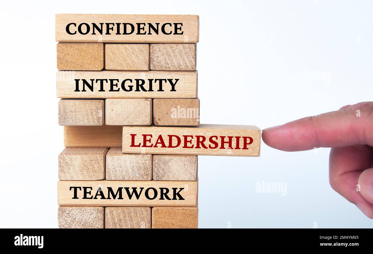 Confidence, integrity, leadership and teamwork text on wood blocks with white background. Business concept. Stock Photo