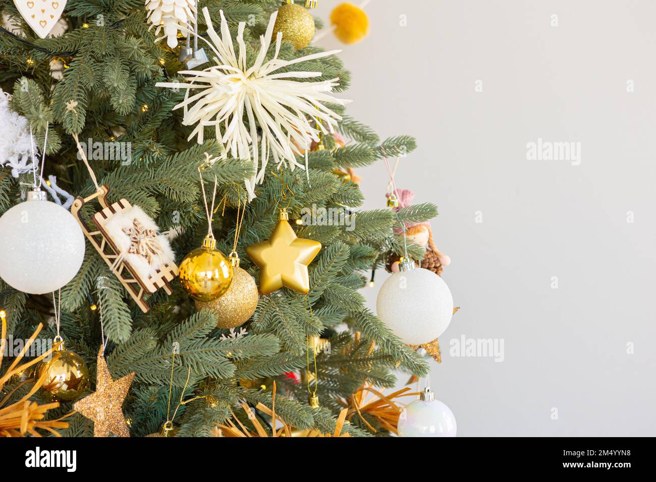 Christmas tree decorated with golden ball toys on a blurry, sparkling ...