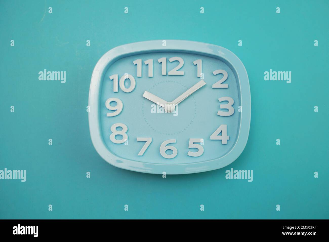 Blue alarm clock top view on Blue background Stock Photo - Alamy
