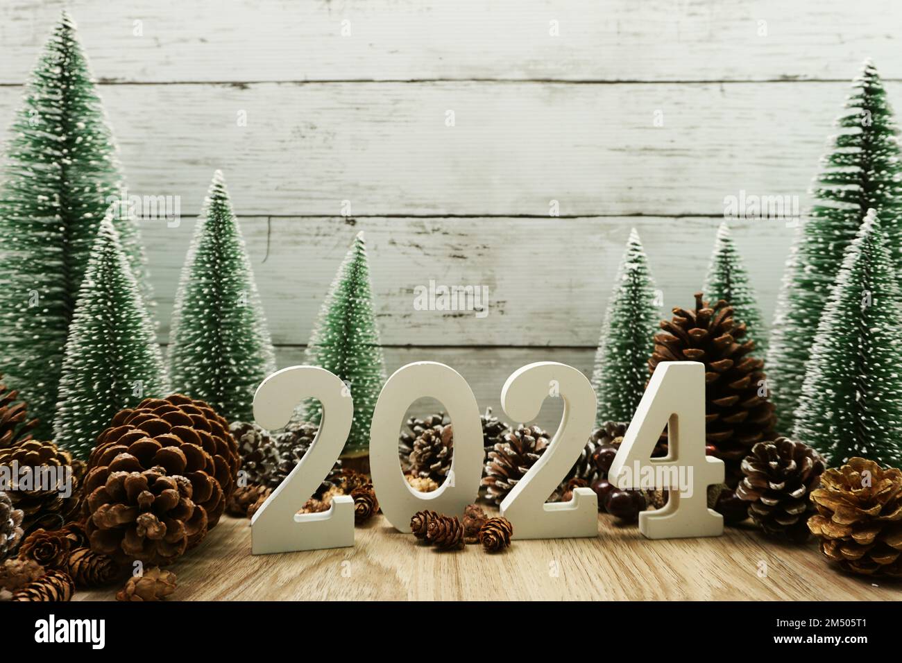 Happy New year 2024 decoration with Christmas tree and pine cones on