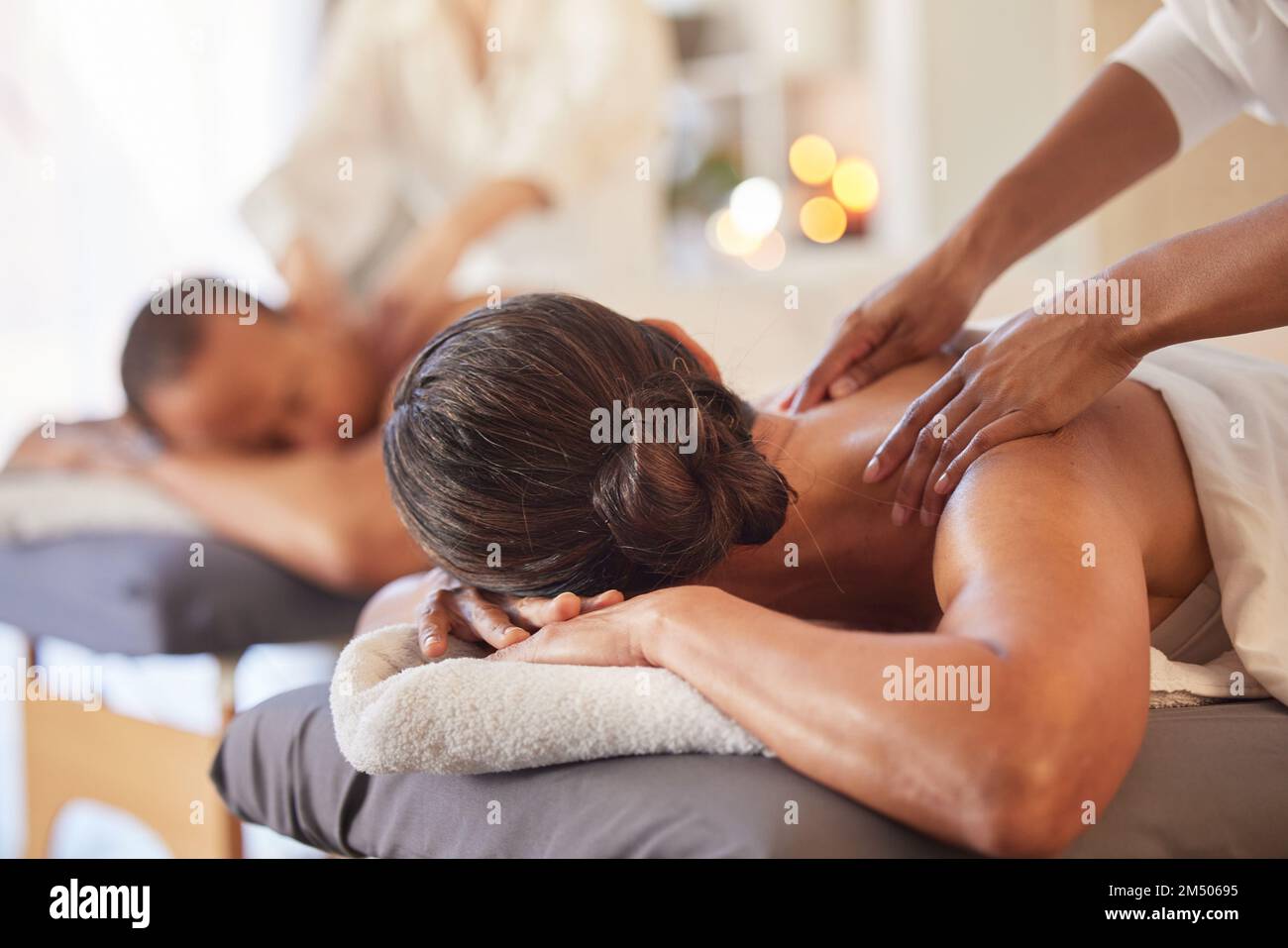 Massage, relax and peace with couple in spa for healing, health and zen treatment. Detox, skincare and beauty with hands of massage therapist on man Stock Photo