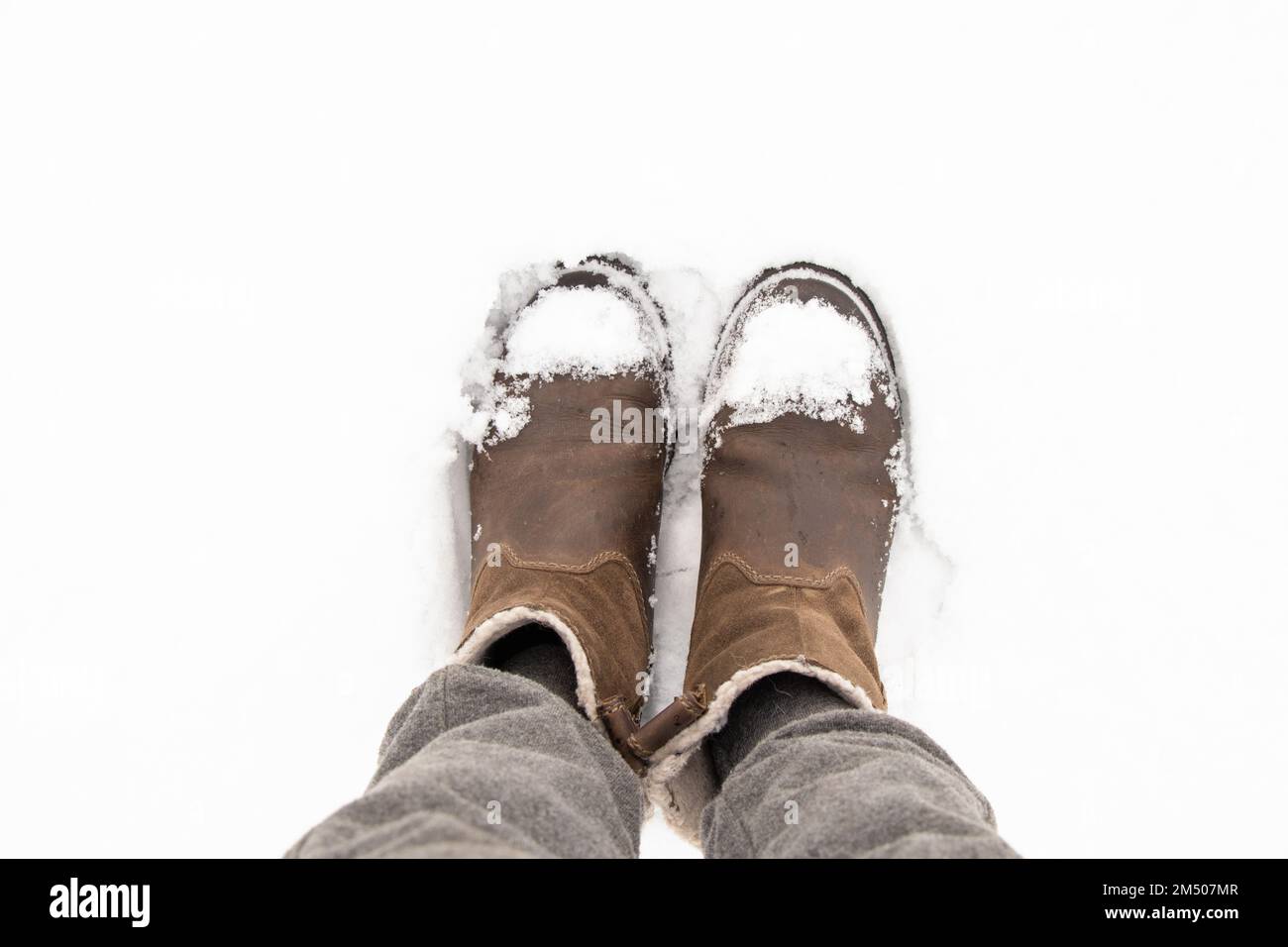 women's boots in the snow top view Stock Photo