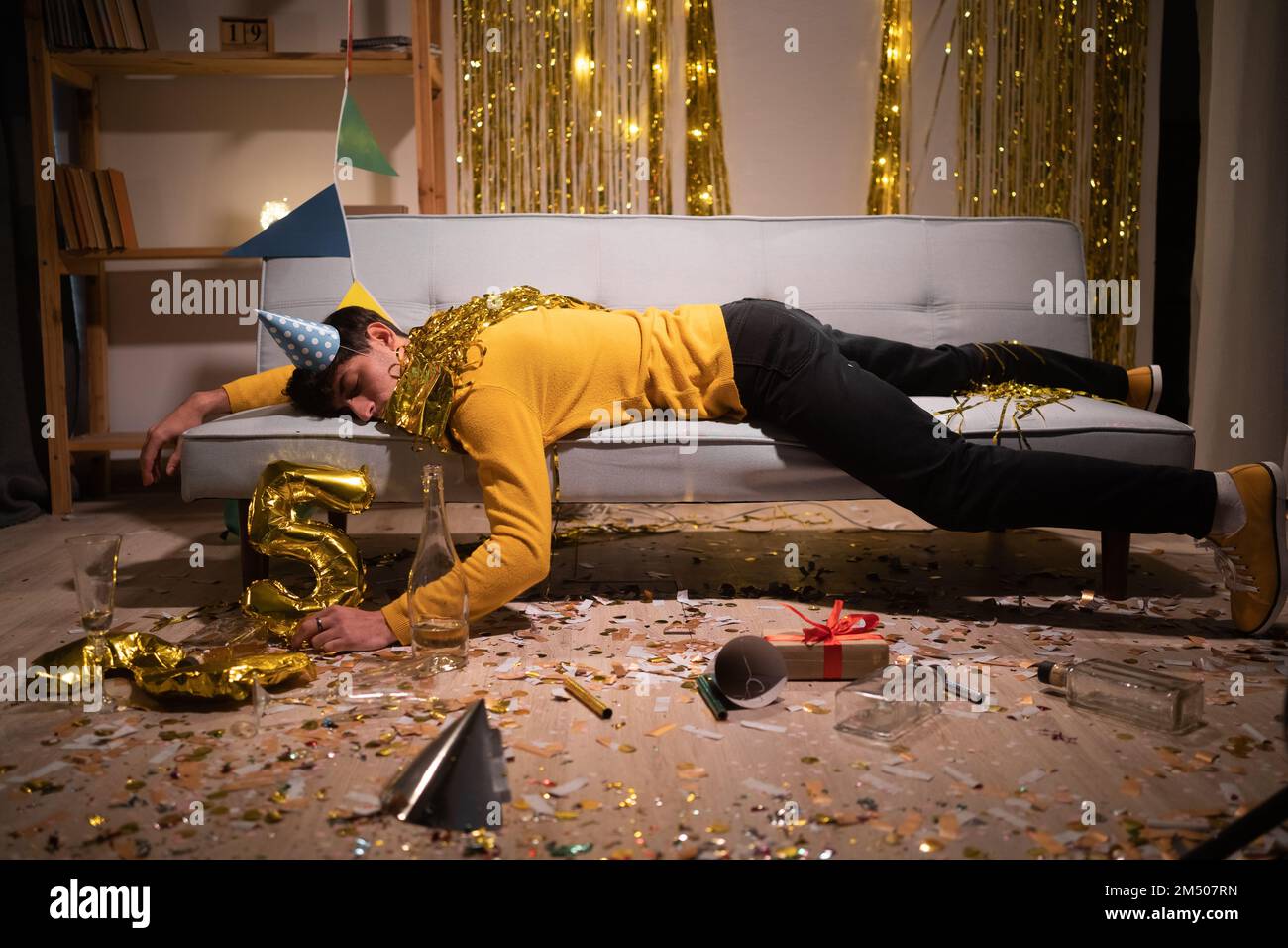 Drunk man sleep in room after birthday party. Copy space Stock Photo