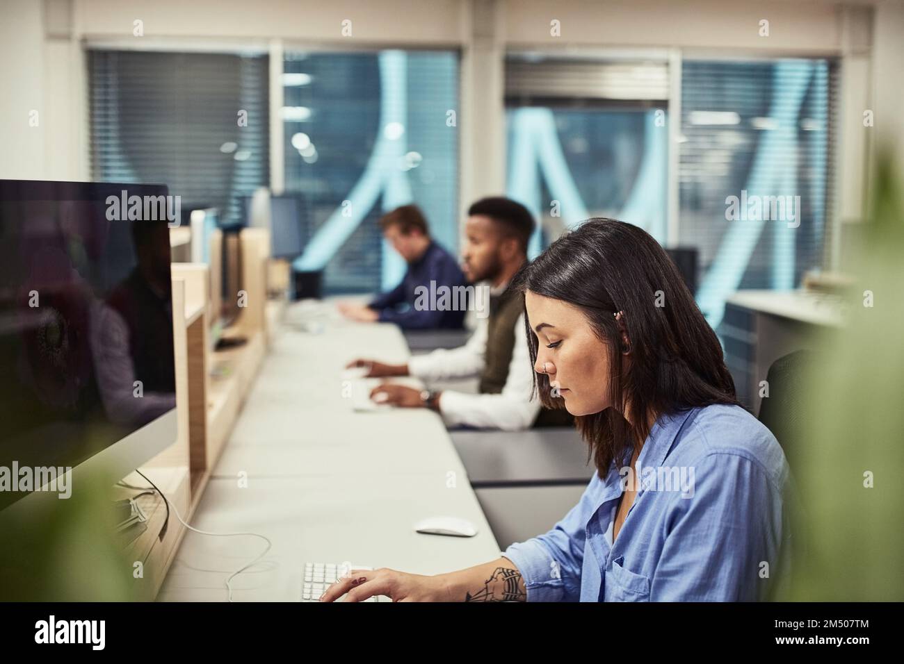 Theyre innovators of the creative world. a group of designers working on computers in an office. Stock Photo