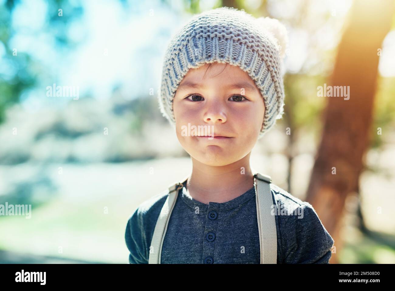I love playing outdoors. Portrait of an adorable little boy playing outside. Stock Photo