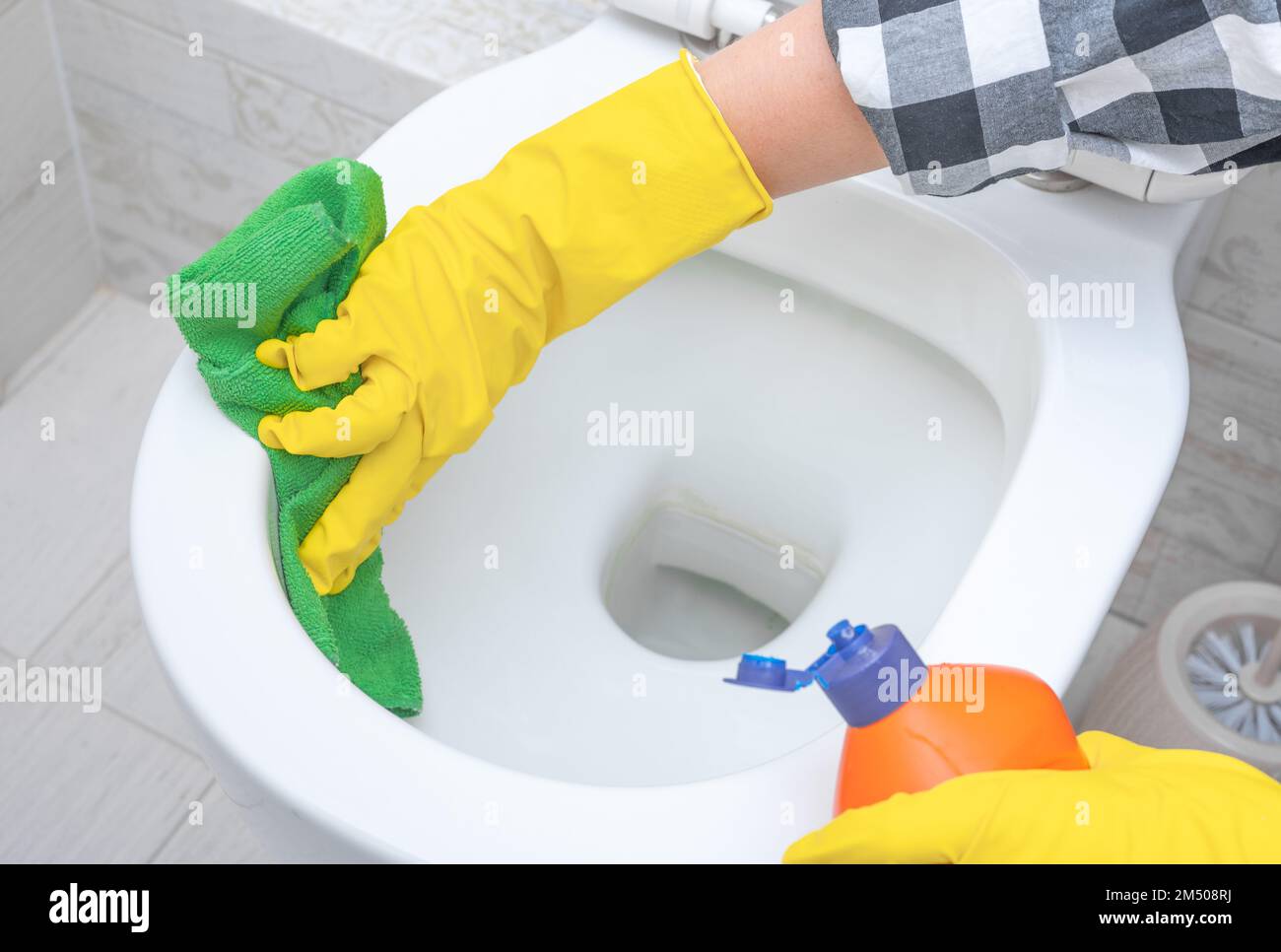 Cleaning service. Close up hand with detergent cleaning toilet bowl in