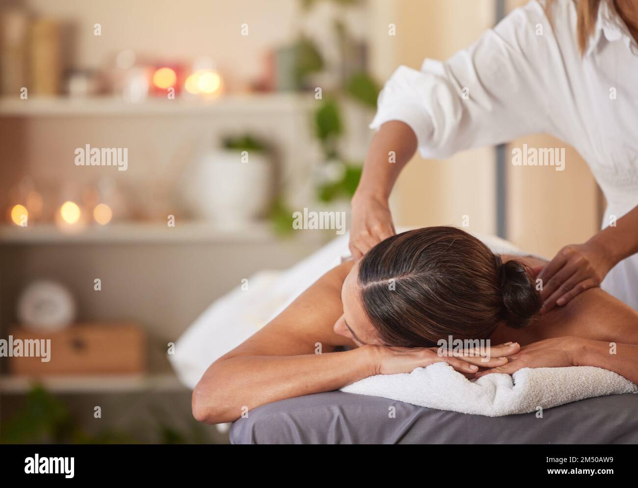 Massage, relax and peace with woman in spa for healing, health and zen treatment. Detox, skincare and beauty with hands of massage therapist on Stock Photo