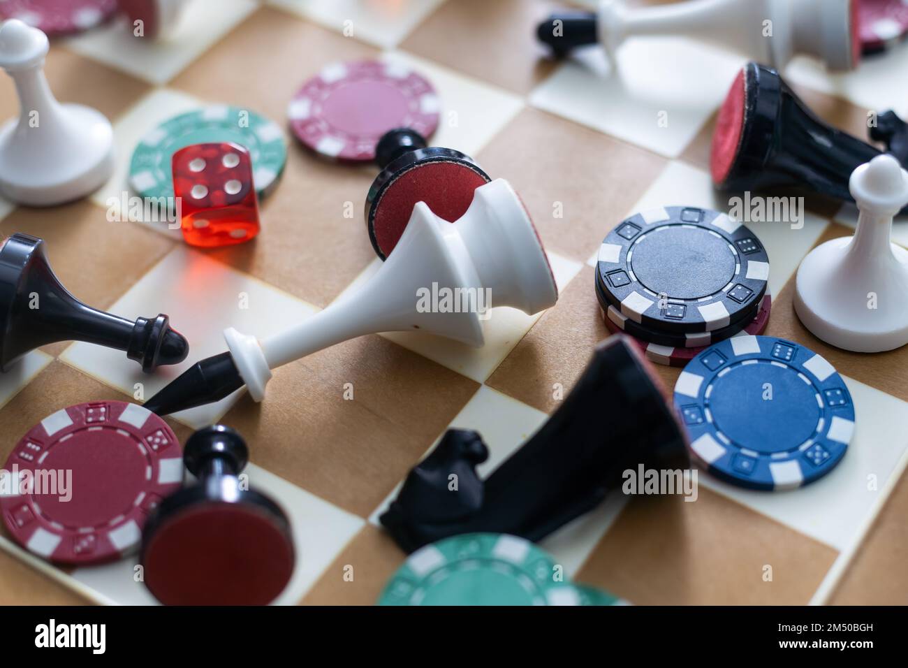 Wooden checkers, chess pieces, playing cards, board games on a light