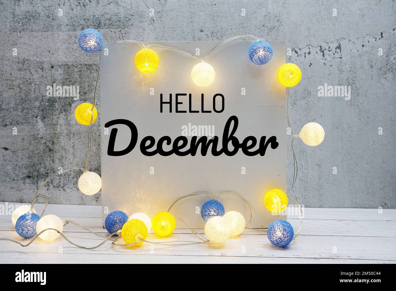 Hello December text message with LED cotton ball decoration on wooden ...