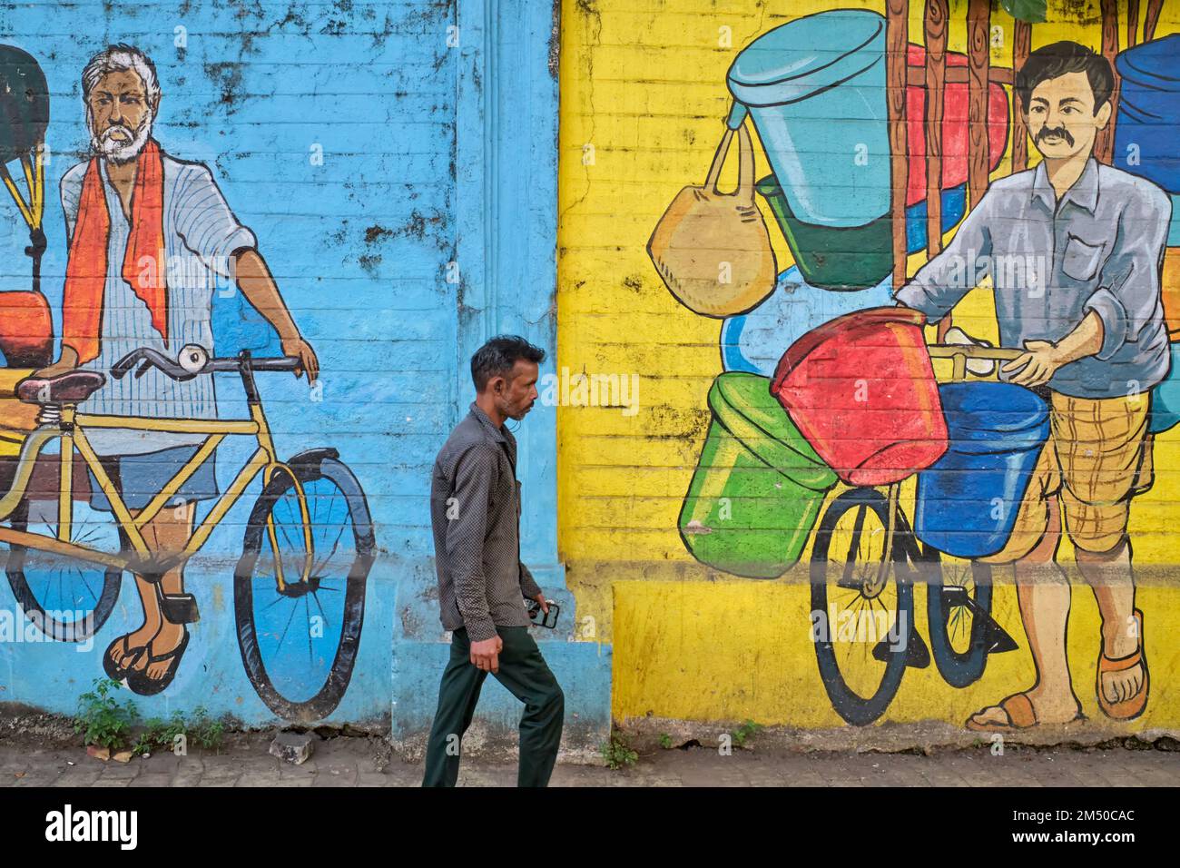 A Man Passes A Colorful Wall Painting In The Byculla Area Of Mumbai 