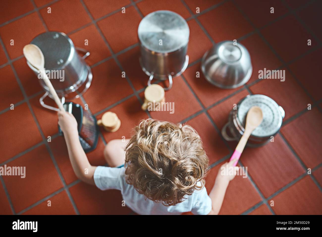 You see pots and pans, he sees a drum set. High angle shot of an unrecognizable little boy