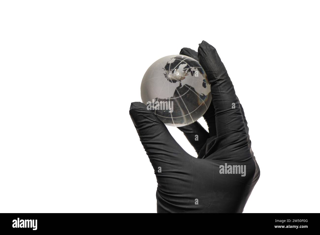 hand in black gloves holds a glass planet globe on a white Stock Photo