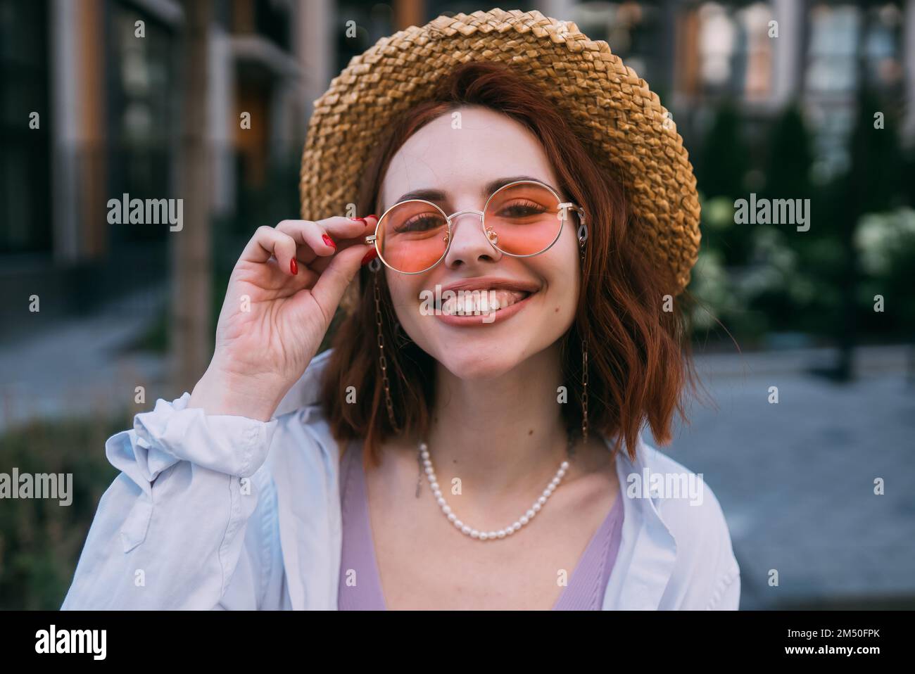 Young woman with toothy smile in outdoors Stock Photo - Alamy