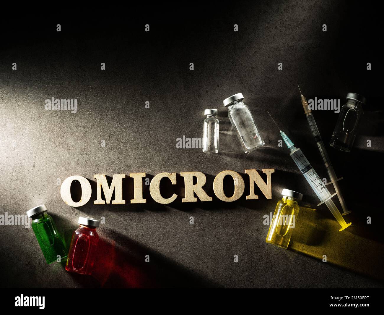 Omicron word, syringe and drugs Stock Photo