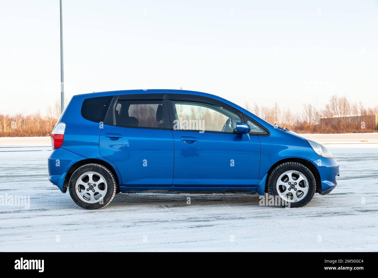 Novosibirsk, Russia - 12.09.2022: Blue Honda Fit car exterior view on the winter backgound on parking. Stock Photo