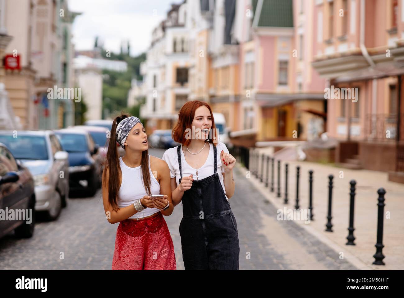 two young women are walking in the city Stock Photo - Alamy