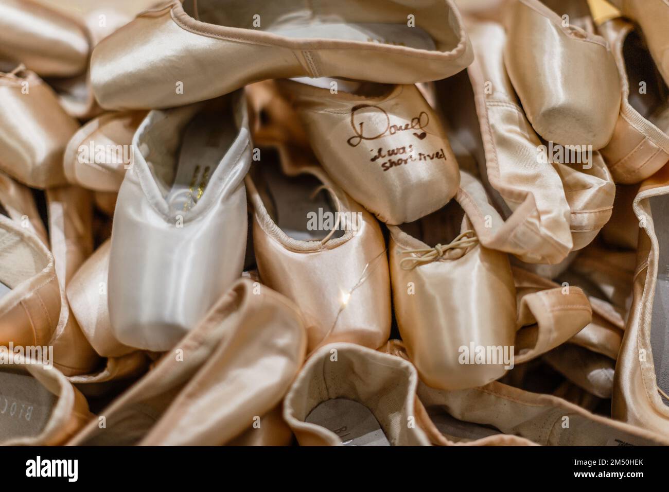 A golden display of ballet shoes. Stock Photo