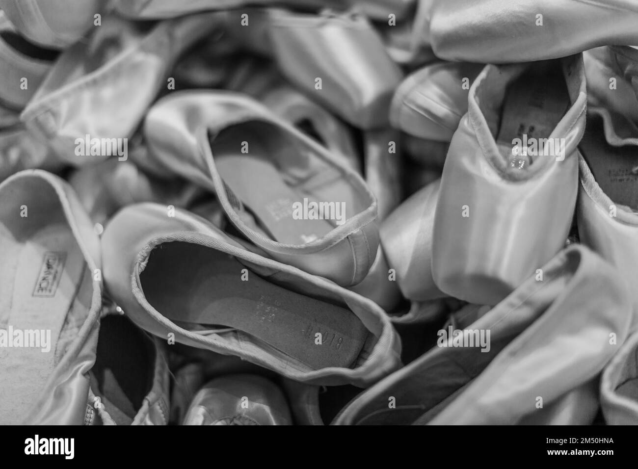 A black and white display of ballet shoes. Stock Photo