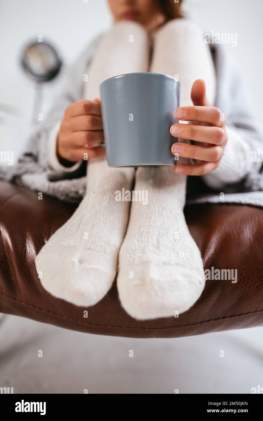 Close up photo sweet woman relaxing with hot beverage covered blanket wearing domestic home apparel clothes outfit sit comfy armchair Stock Photo