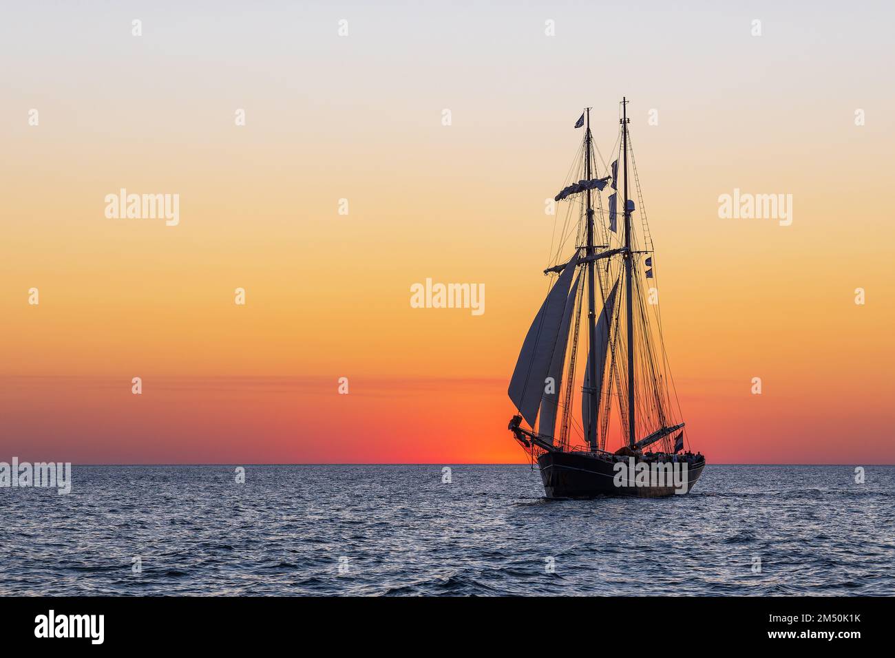 Sailing Ship In The Sunset At The Hanse Sail In Rostock Stock Photo - Alamy