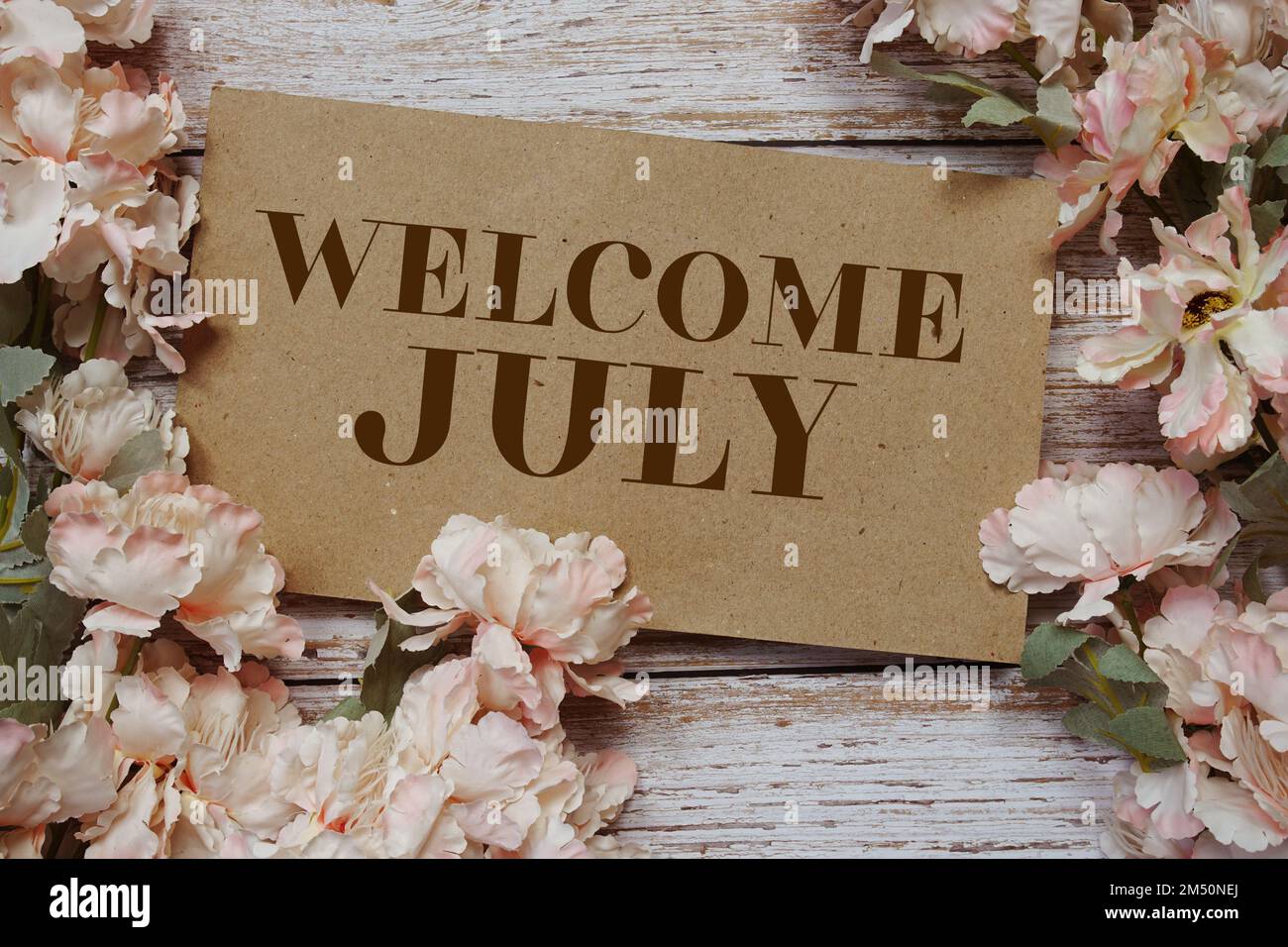 July Text Frame Welcome July typography text with flowers frame on wooden background ...