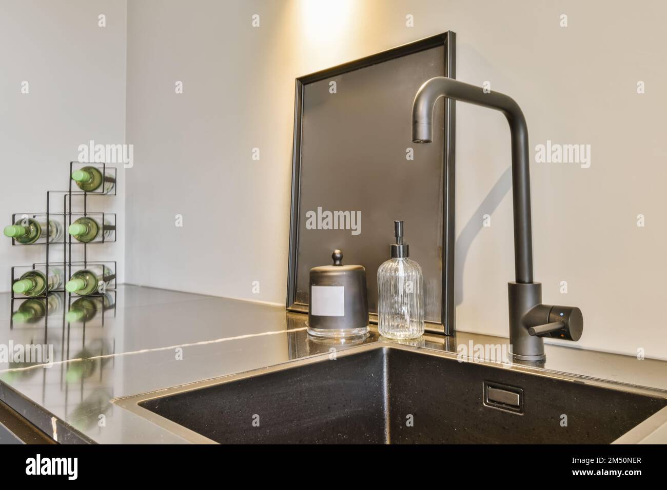 a kitchen sink with green apples on the countertop in front of it and ...