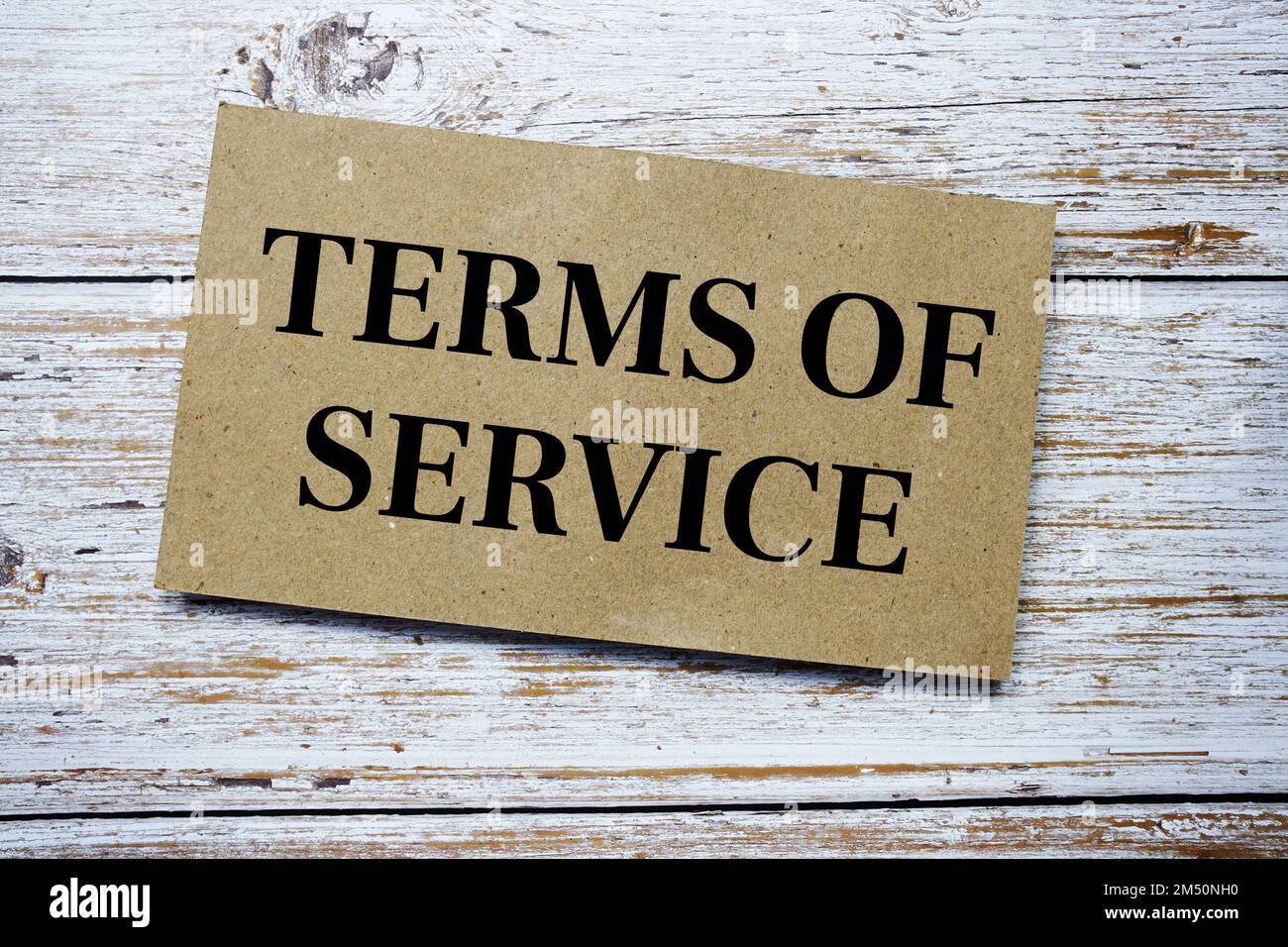 Terms of Service written on paper card top view of wooden background Stock Photo