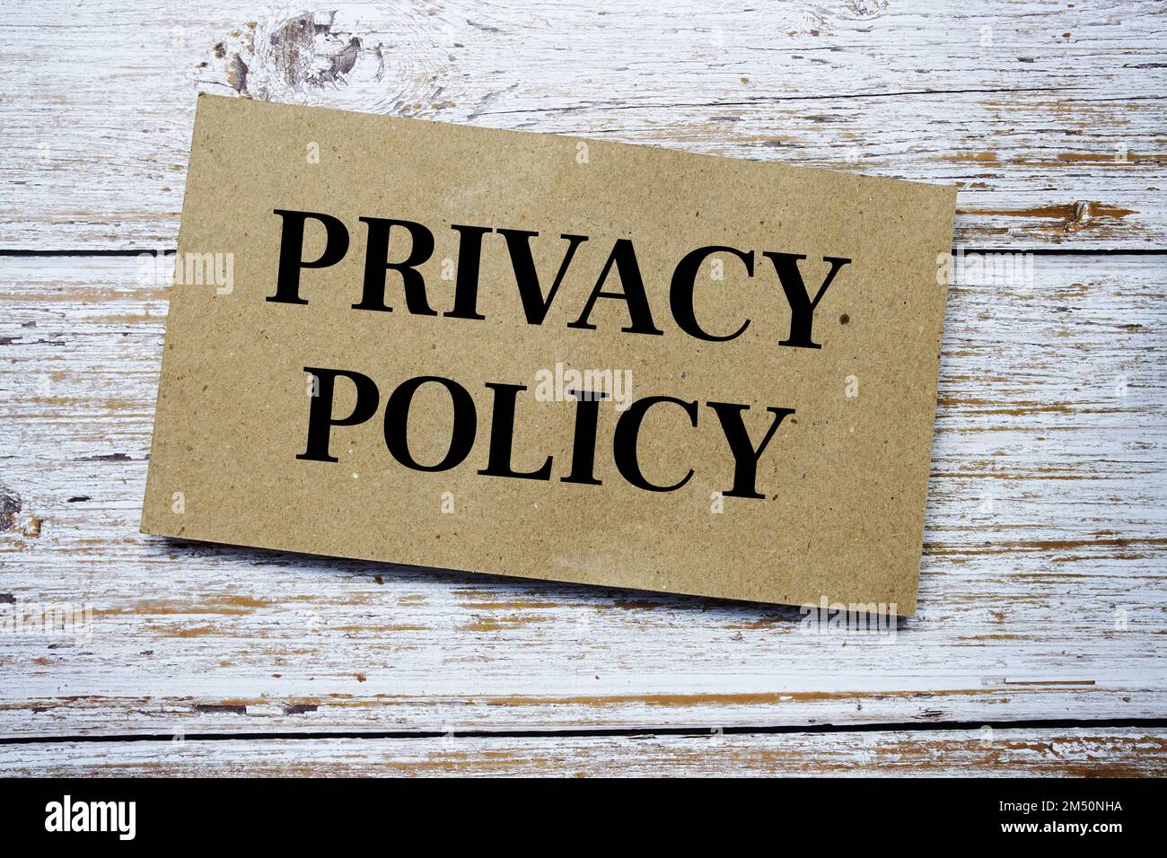 Privacy Policy written on paper card top view of wooden background Stock Photo