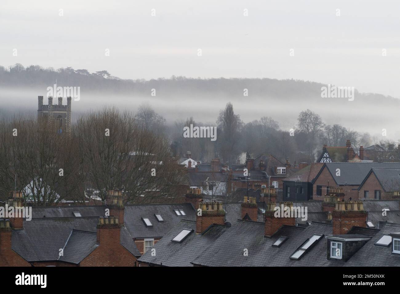 UK Weather, 24 December 2022: On Christmas Eve in Henley-on-Thames early morning fog from the river rises above the town's rooftops and the square tower of St Mary's church. With the weather turning mild and wet in England there will not be a white Christmas this year. Anna Watson/Alamy Live News Stock Photo