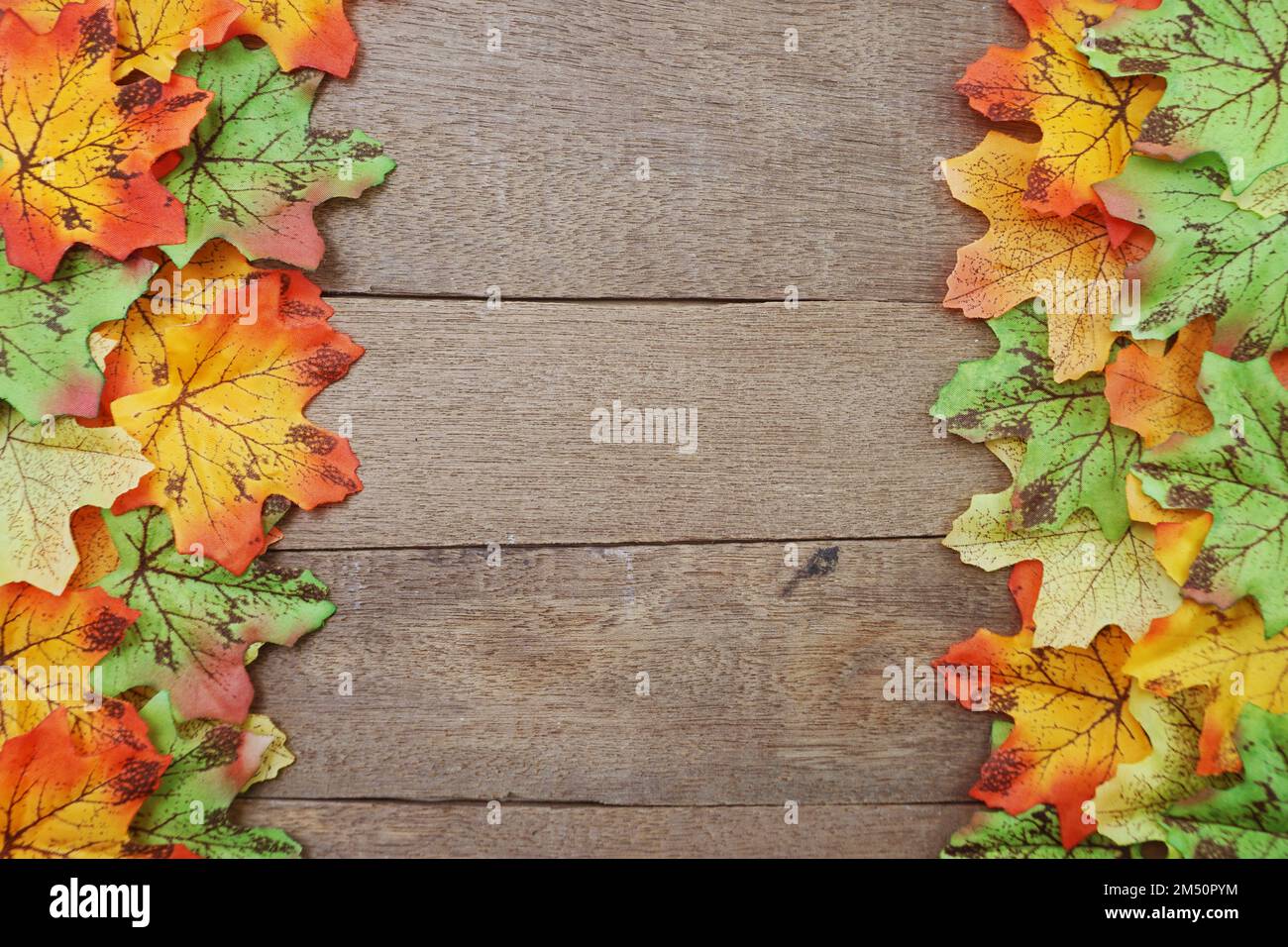 Autumn Maple leave border frame on wooden background Stock Photo - Alamy