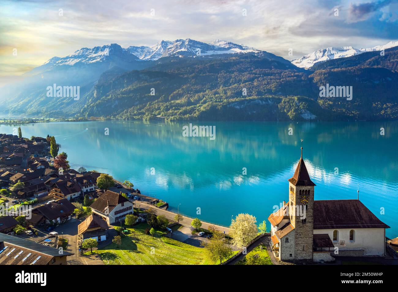 beautiful idylic nature scenery of lake Brienz with turquoise waters. Switzerland, Bern canton. Aerial view with little church in the morning light Stock Photo