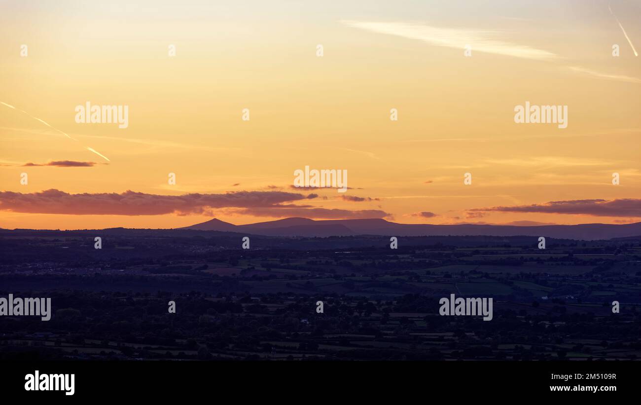 Sunset over the Brecon Beacons viewed from Cam Long Down, Dursley, Gloucestershire, UK Stock Photo