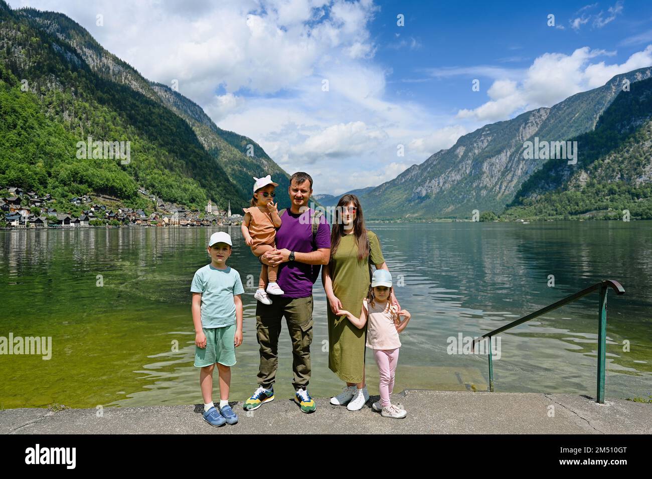 Portrait of family with three children over Austrian alps lake in Hallstatt, Salzkammergut, Austria. Stock Photo