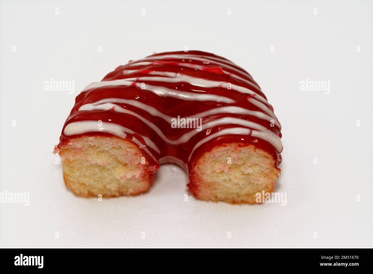 Strawberry flavor ring donut with white chocolate sauce, glazed, yeast raised, American style ring doughnut, type of food made from leavened deep frie Stock Photo
