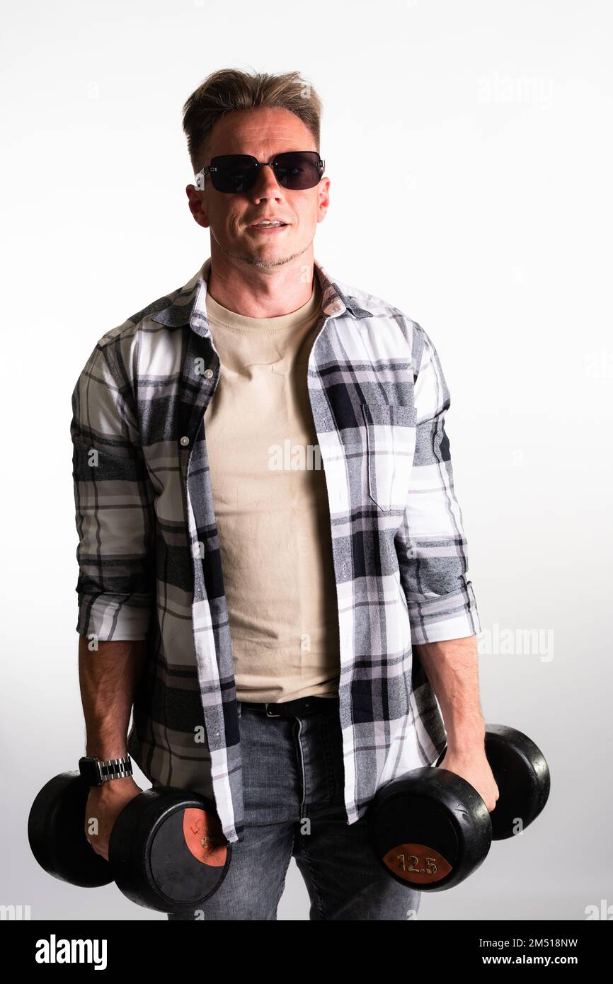 Casual guy lifting a weight isolated on white background Stock Photo