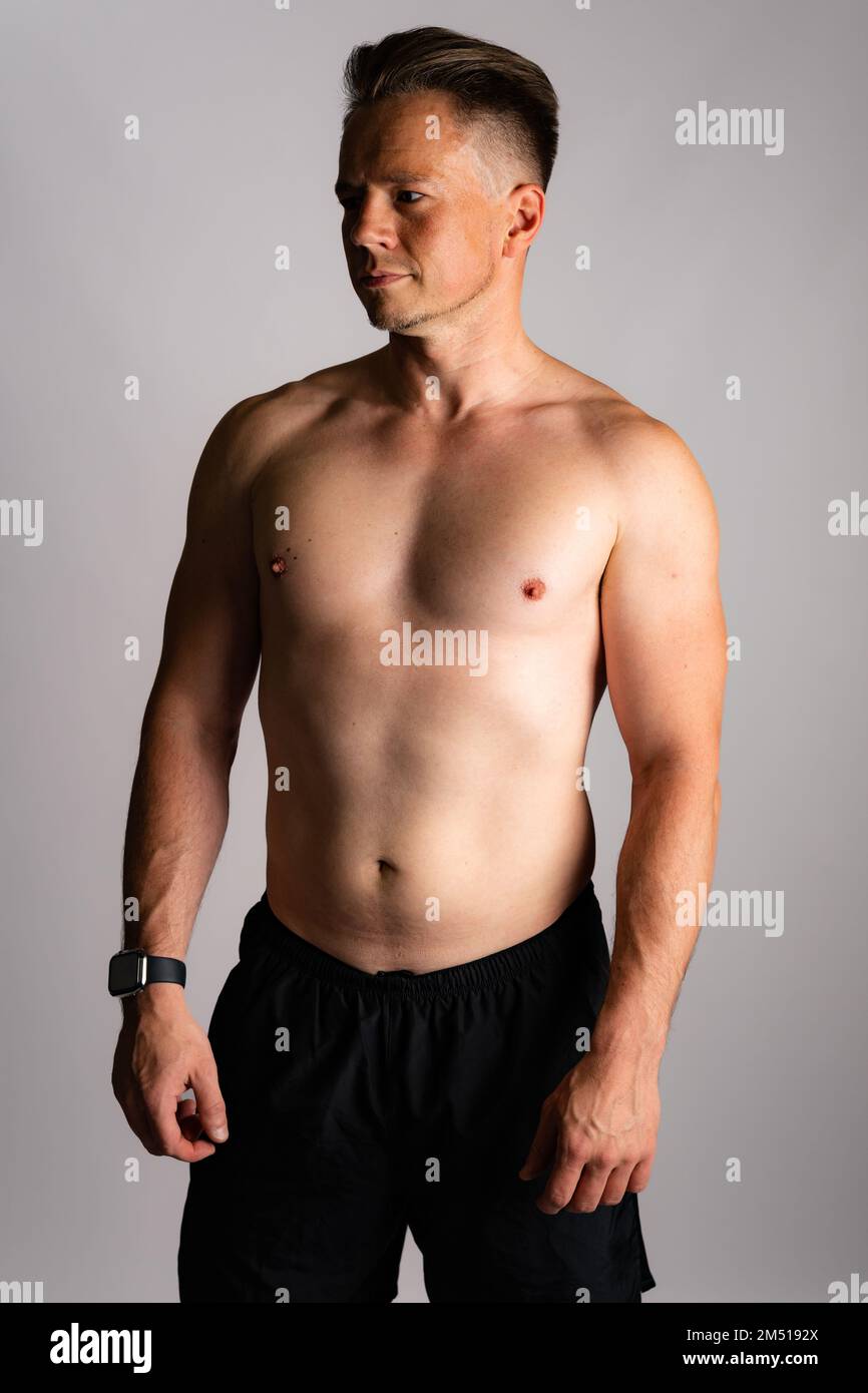 Sexy portrait of muscular handsome topless male isolated against a white background Stock Photo