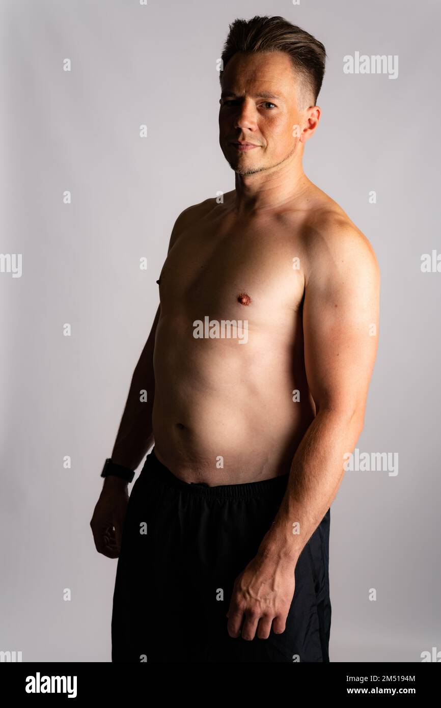 Sexy portrait of muscular handsome topless male isolated against a white background Stock Photo