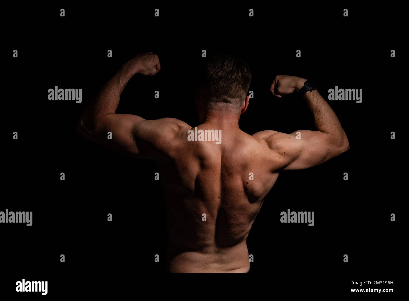 Sexy portrait of muscular handsome topless male isolated against a grey background Stock Photo