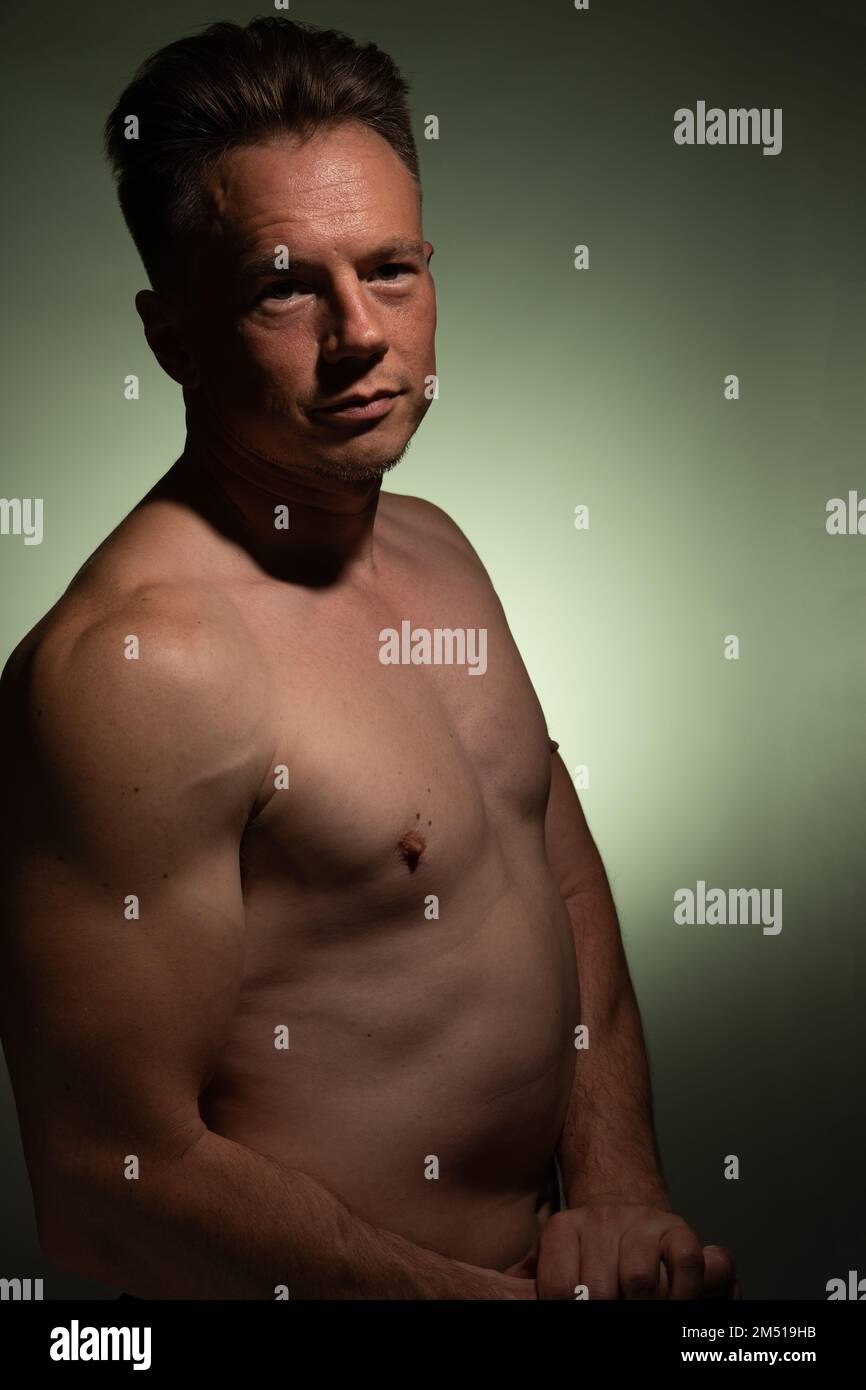 Sexy portrait of muscular handsome topless male isolated against a coloured background Stock Photo
