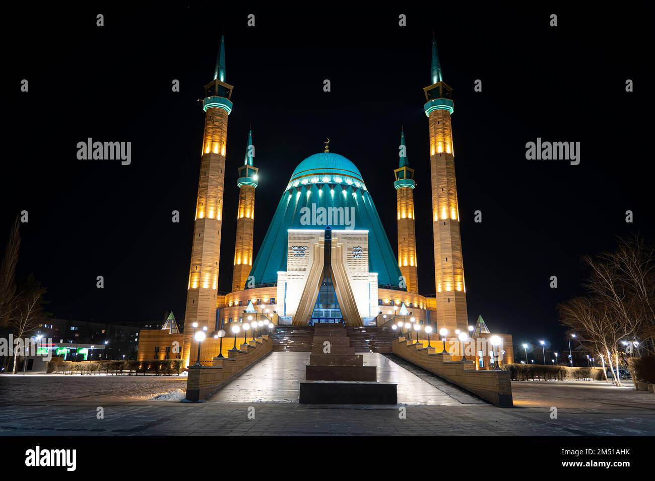 A Mashkhur Jusup Mosque in the center of Pavlodar on a blue sky background in winter at night. Stock Photo