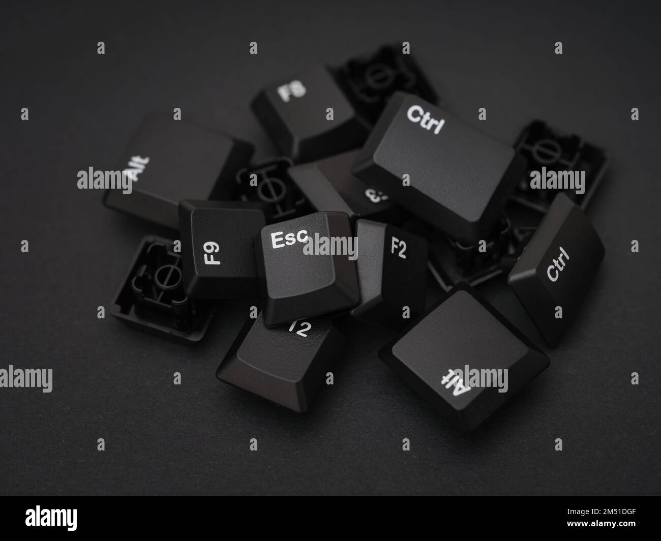 A pile of computer keys on a black background. Close-up. Stock Photo