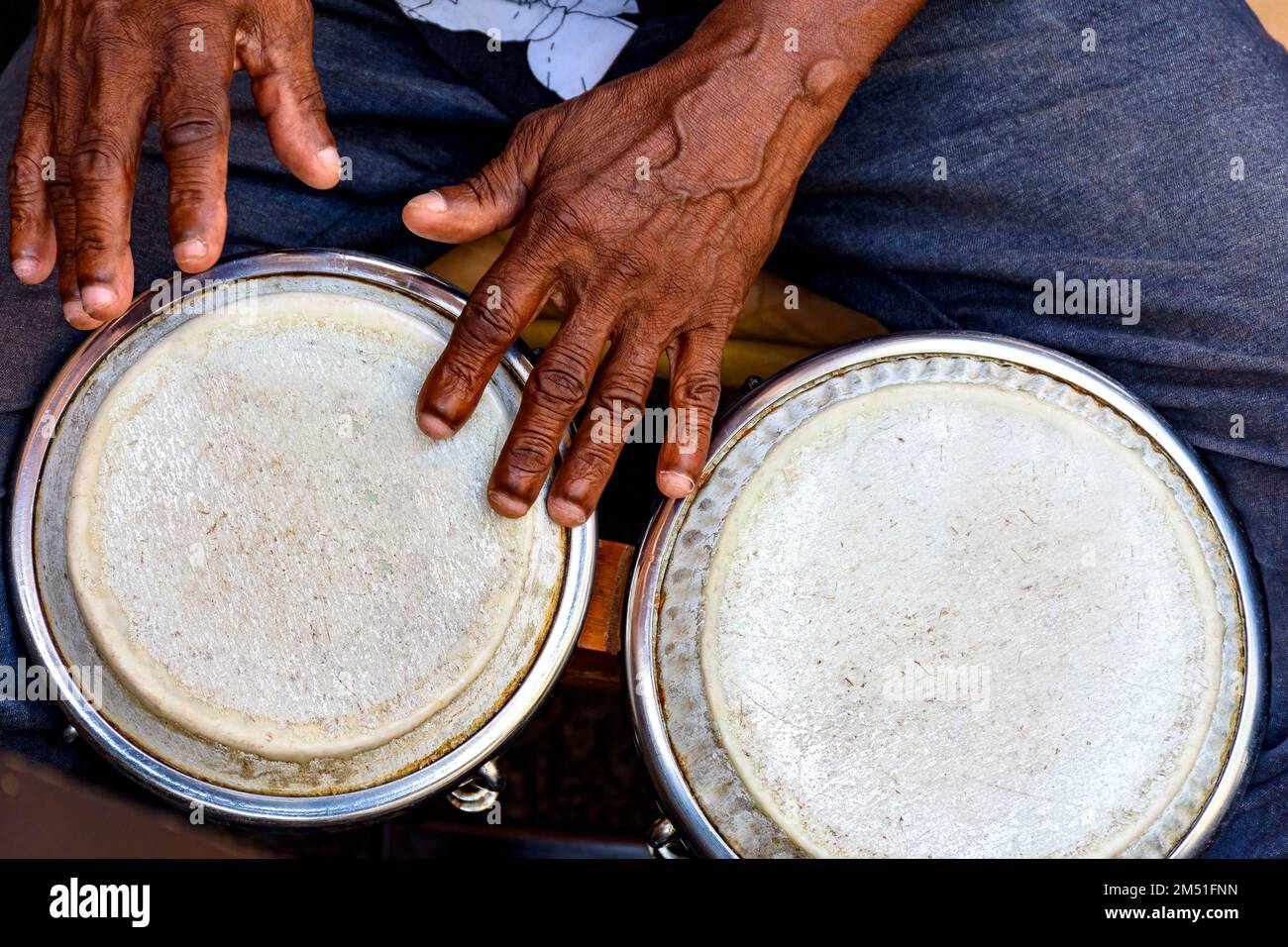 Hands and istrument of musician playing bongo in the streets of Pelourinho in Salvador in Bahia Stock Photo