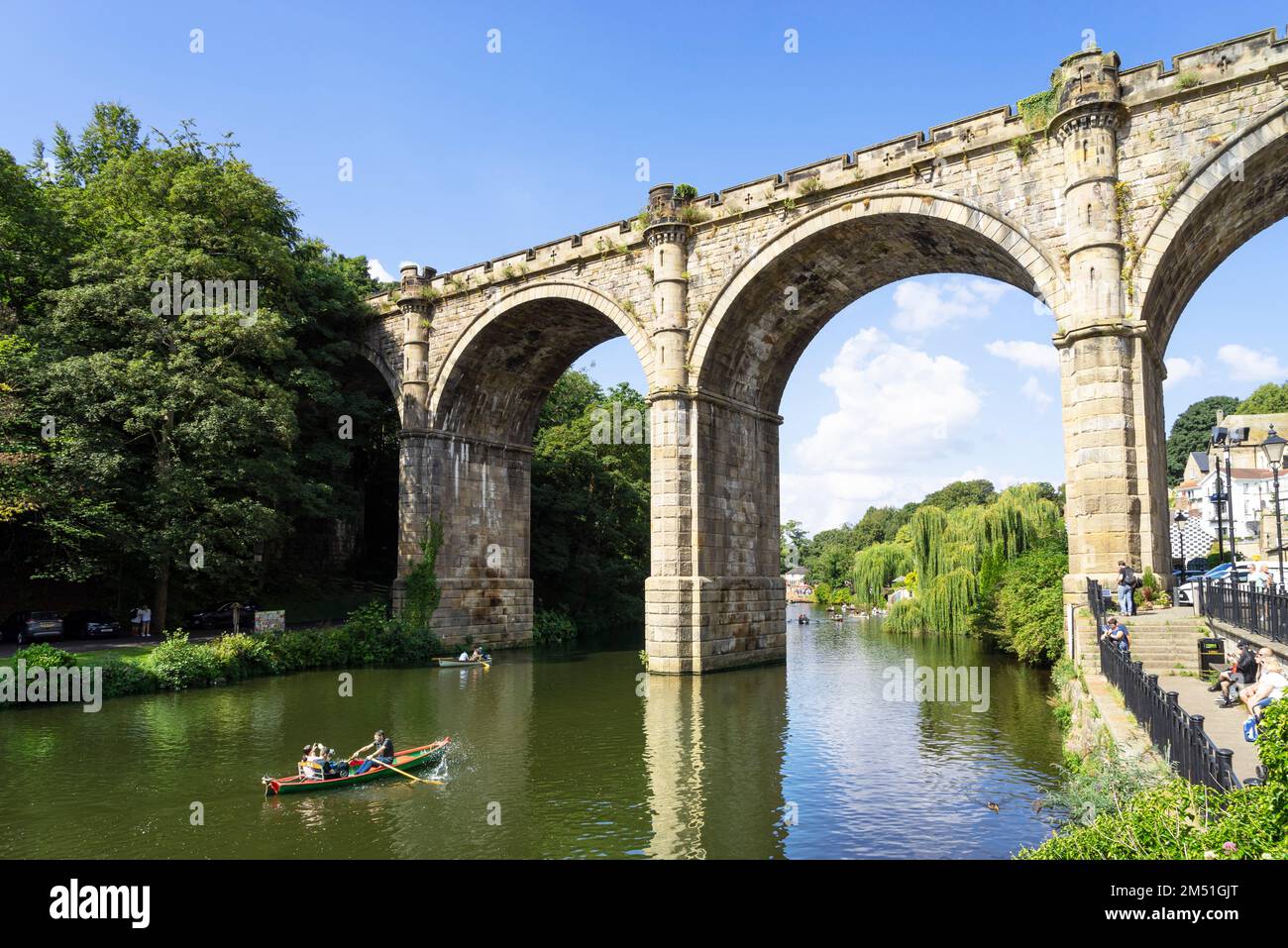 Knaresborough viaduct over the River Nidd with people in a hired boat rowing under the arches at Knaresborough North Yorkshire England UK GB Europe Stock Photo